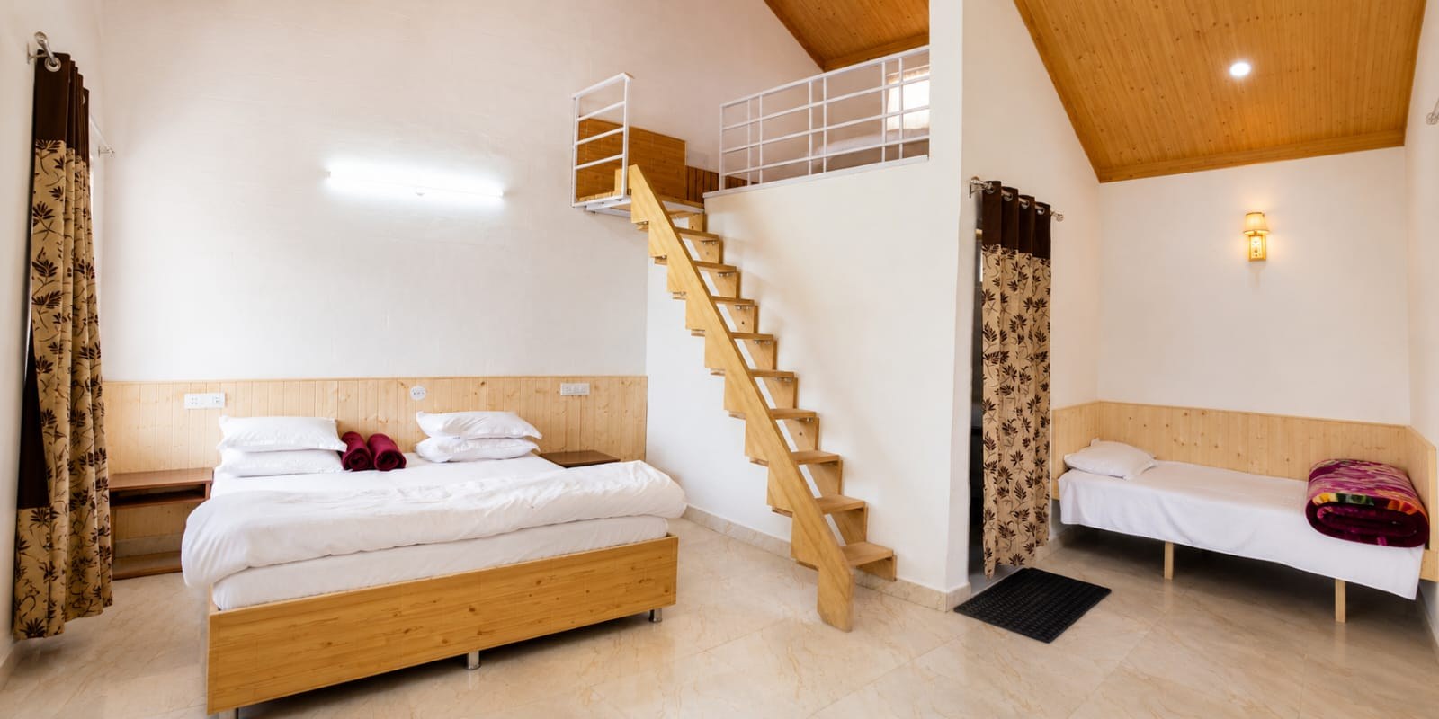 Spacious cottage interior with double bed, single bed and mezzanine loft at The Glide Inn Shimla