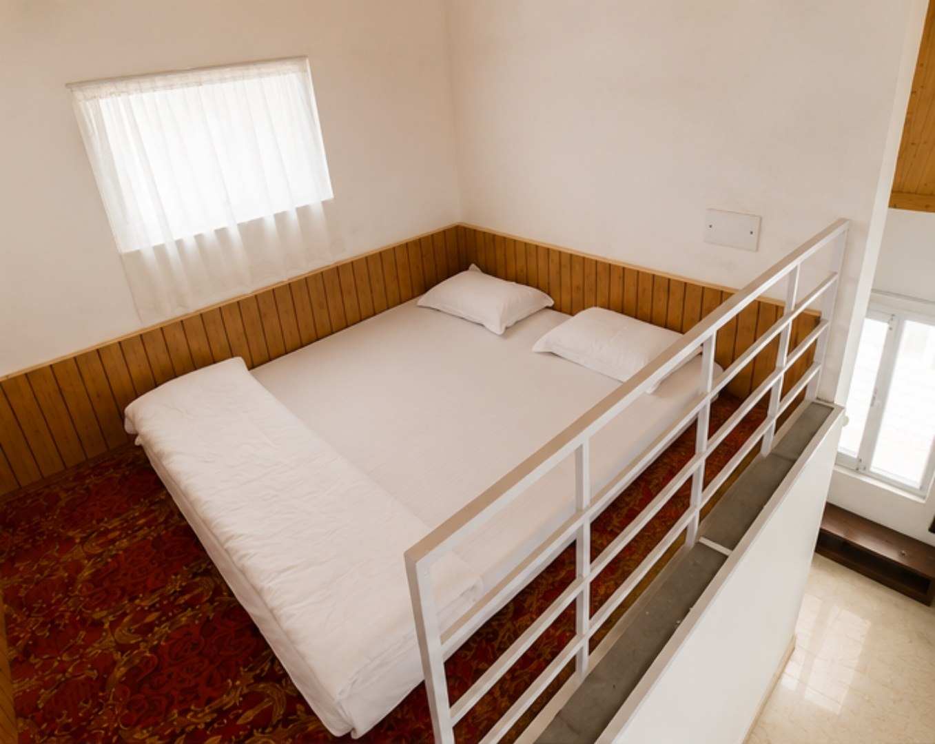 Cottage loft bedroom with mezzanine sleeping area at The Glide Inn Shimla