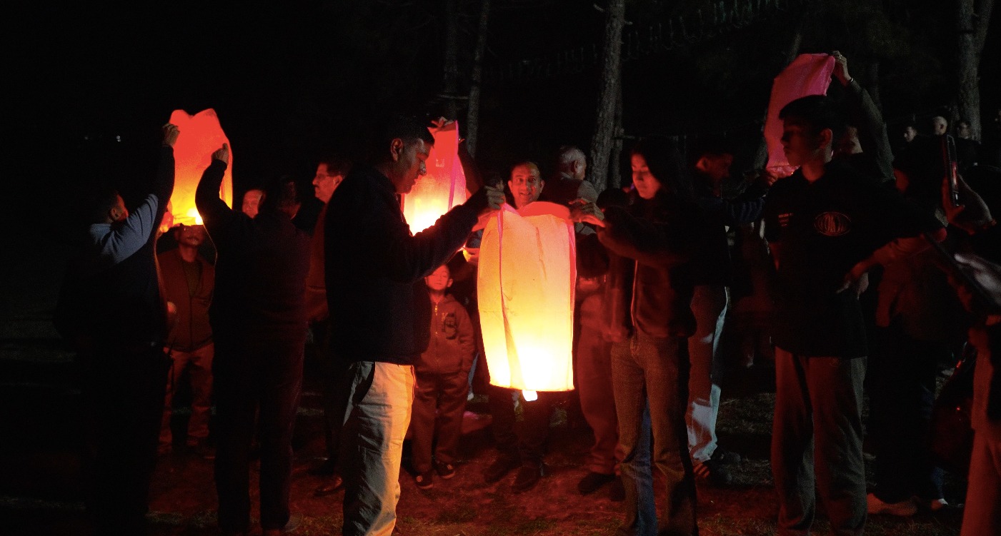 Guests releasing glowing sky lanterns at night at The Glide Inn