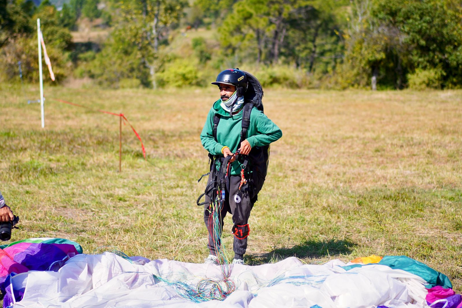 Licensed pilot preparing the paraglider on the launch field at The Glide Inn