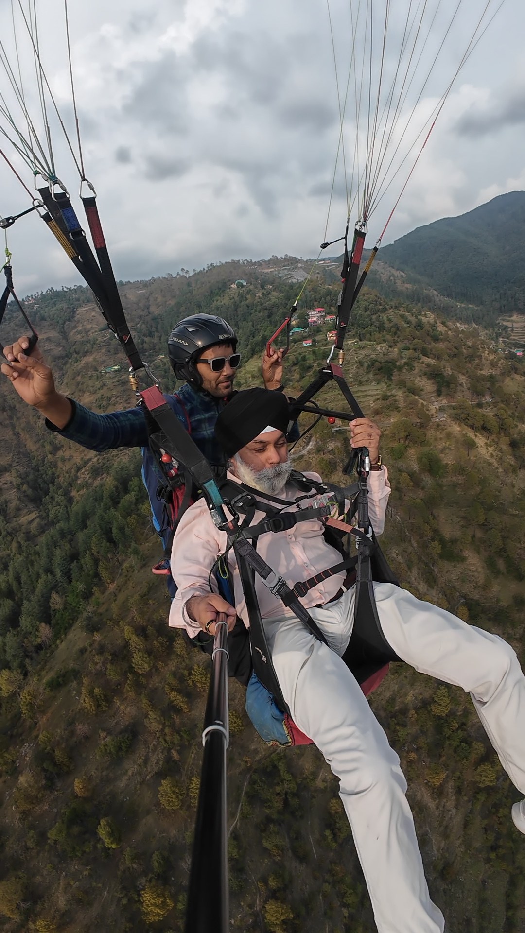 Guest tandem paragliding high above the Junga valley with a certified pilot at The Glide Inn Shimla