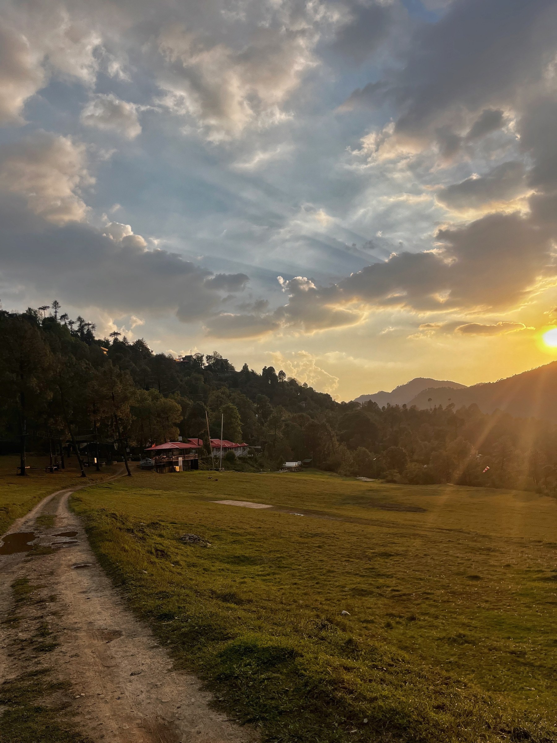 Golden sunset over The Glide Inn resort meadow and red-roofed buildings