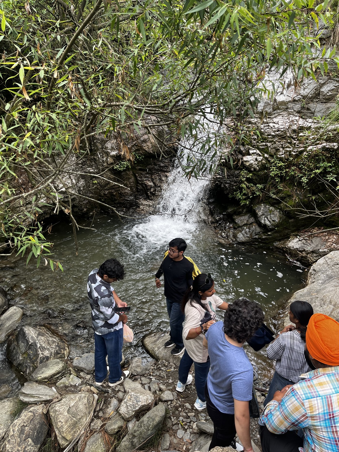 Guests enjoying the waterfall on a guided trek at The Glide Inn